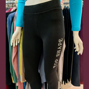 picture of black leggings printed with a white logo on the thigh: Top Shape. bikinn.com