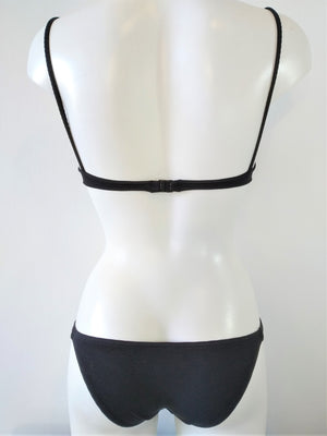 Back view of the black bikini set, strapless lightly padded bra, regular bikini bottom, embellished with one flat black ring on each sides. bikinn.com