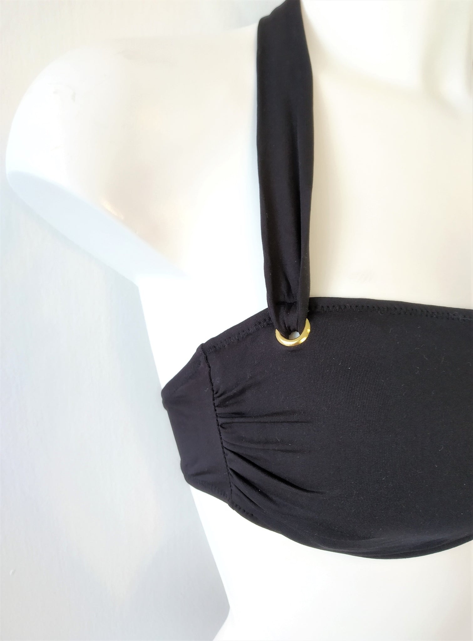 close detail of one side of a black bikini bandeau bra. bikinn.com
