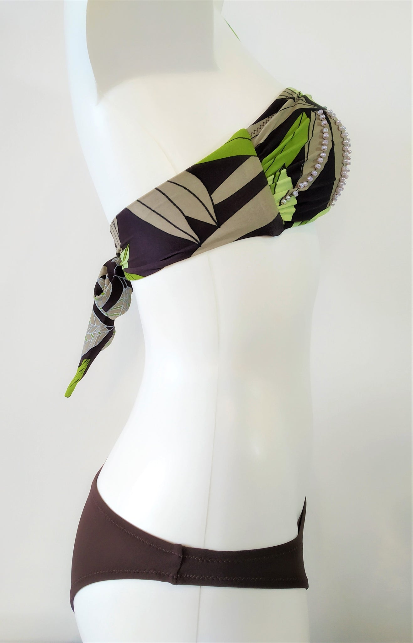 Side view of Strapless bikini set bandeau print with green leaves on brown background Embellishment: handwork of embroidered beads and sequins. bikinn.com