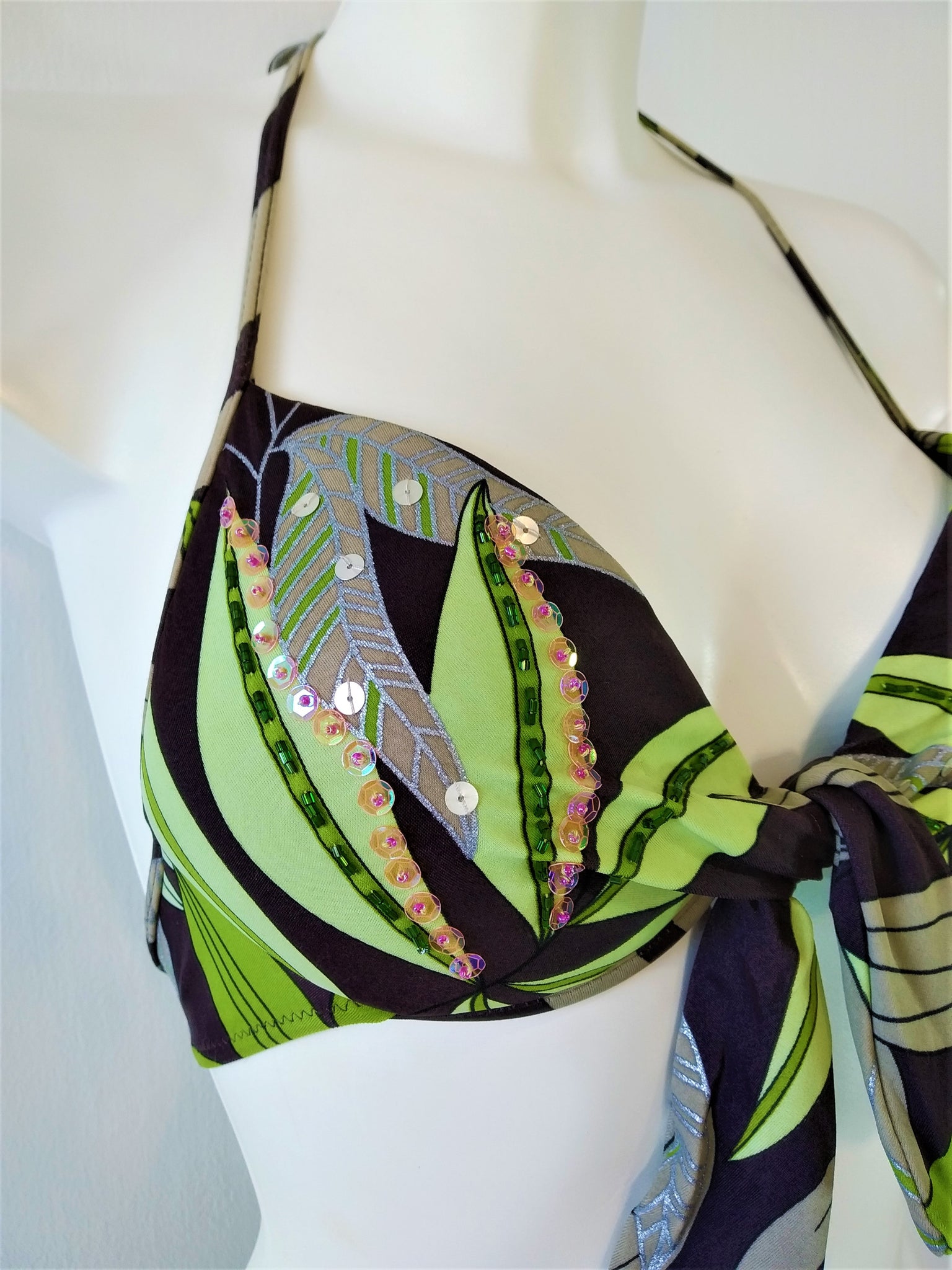 Detail of bikini push-up bra with print of  green leaves on brown background Embellishment: handwork of embroidered beads and sequins. bikinn.com
