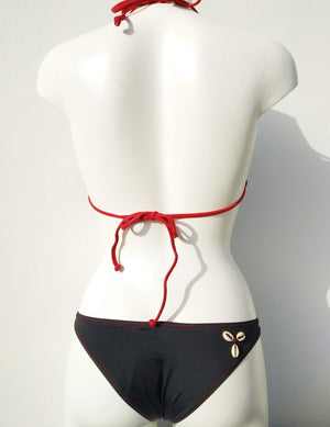 back view of reversed black triangular bikini set with few seashells sewn for decoration along the neckline . bikinn.com