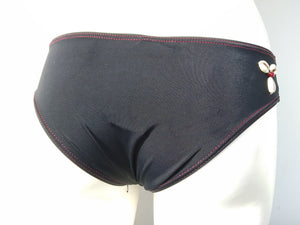 Back view of black low bikini bottom, cheeky bottom with seashells decoration, mix and match collection. bikinn.com