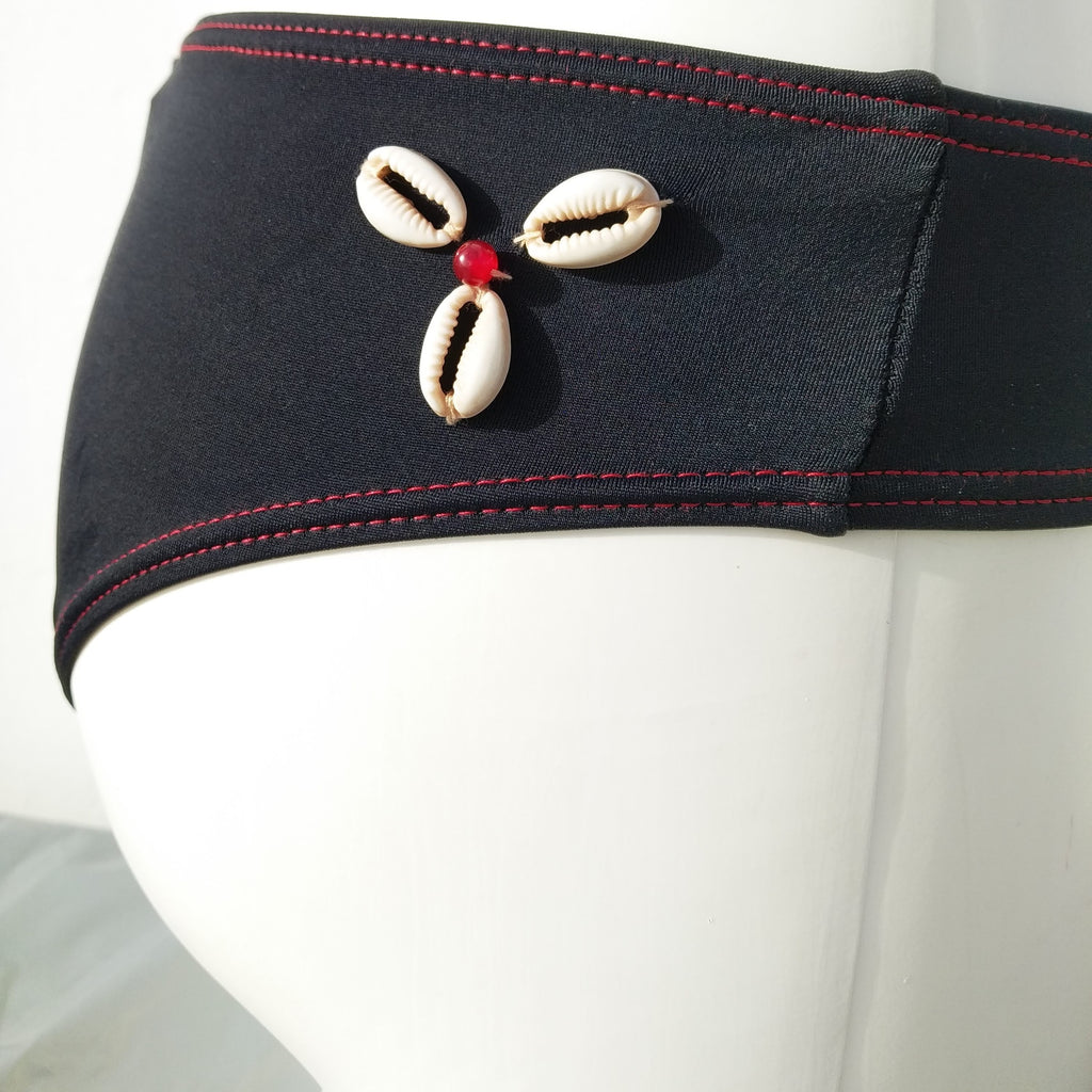 Side view of black low bikini bottom, cheeky bottom with seashells decoration, mix and match collection. bikinn.com