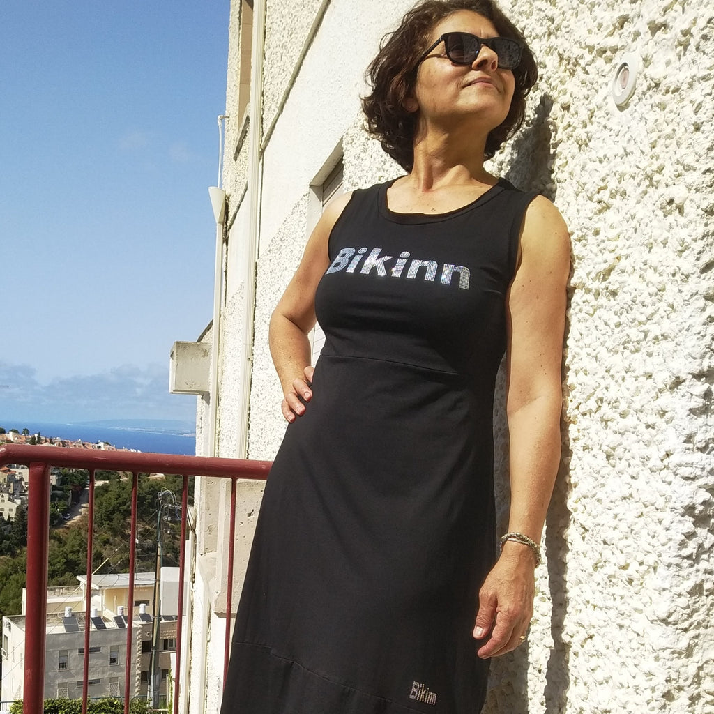 Women standing outside wearing black summer  dress, Rhinestone hotfix  print of Bikinn as front embellishment, Bling-bling fashion. bikinn.com
