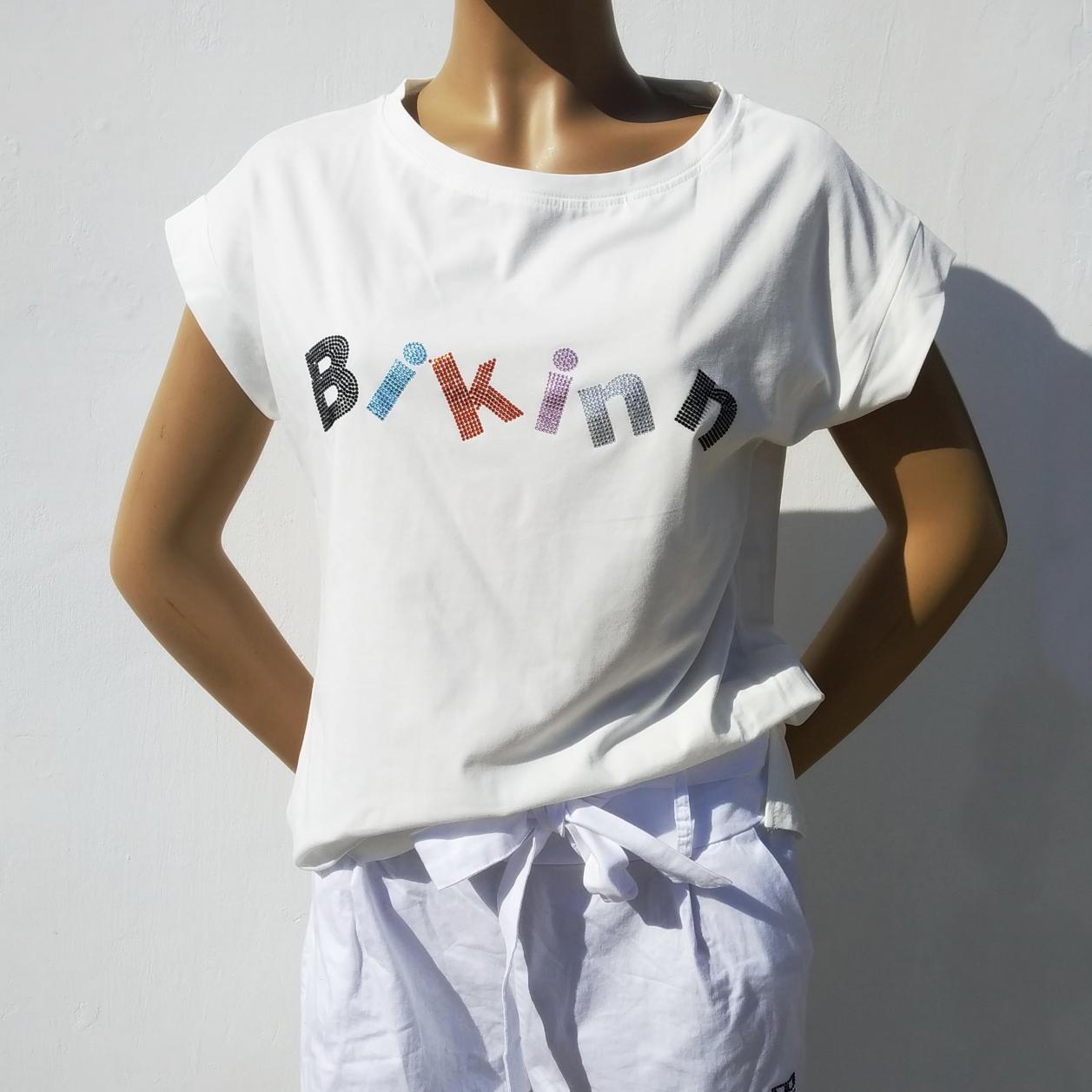 White  short sleeves cotton-lycra T-shirt, multicolor rhinestones crystals printed logo. Bling-bling fashion. bikinn.com