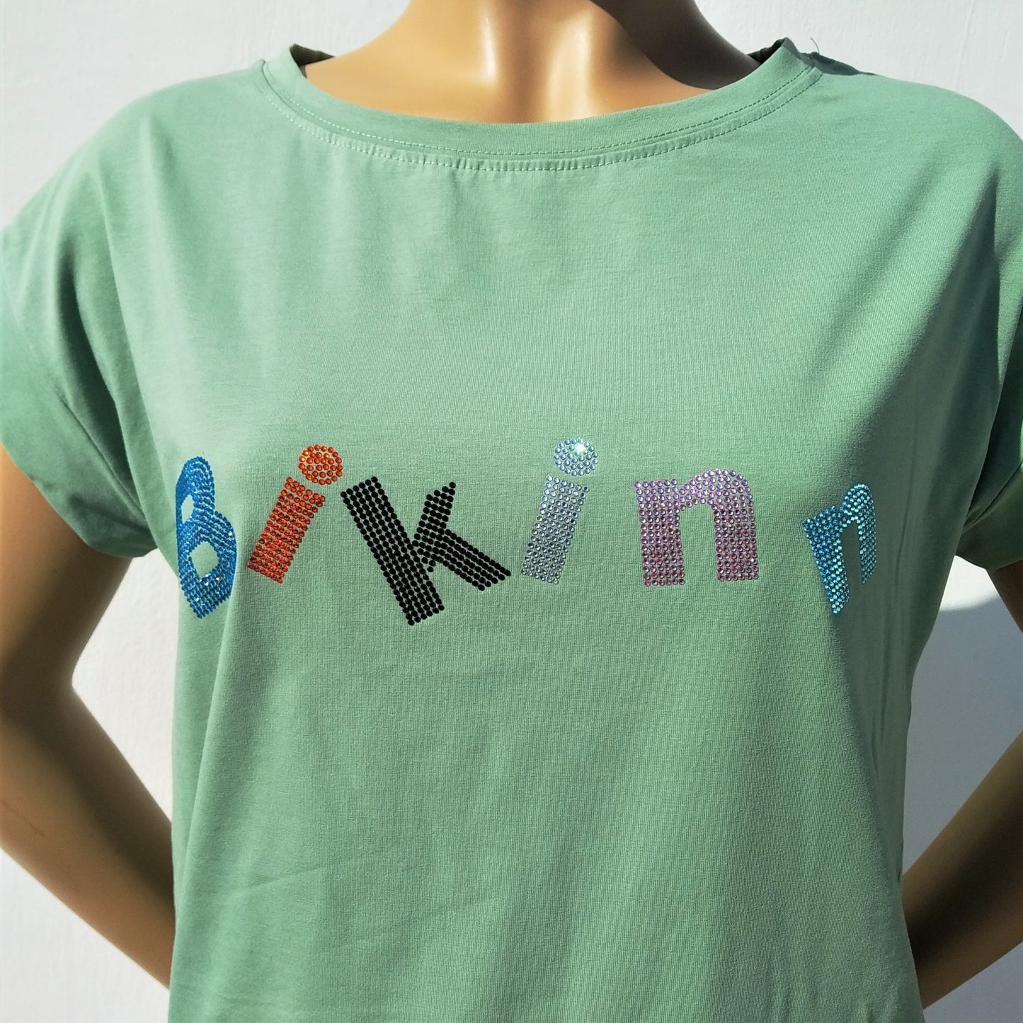 Green  short sleeves cotton-lycra T-shirt, multicolor rhinestones crystals printed logo. Bling-bling fashion. bikinn.com