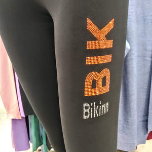 Black long leggings with rhinestones crystals printed logo on left thigh, bling-bling fashion. bikinn.com