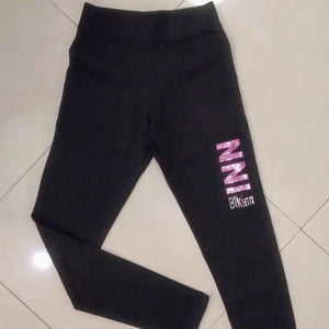 Black long leggings with rhinestones crystals printed logo on left thigh, bling-bling fashion. bikinn.com