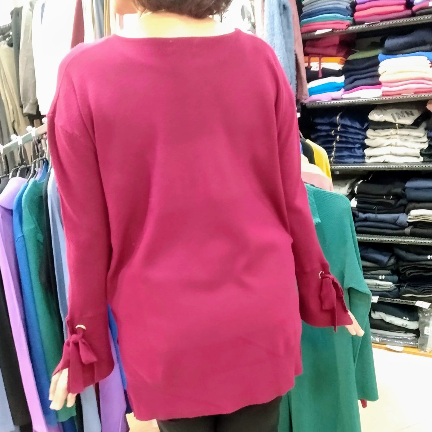 Back view of a women wearing a large bordeaux tunic fine cotton sweater, with a crystal logo printed on the front: "BIKINN". bikinn.com